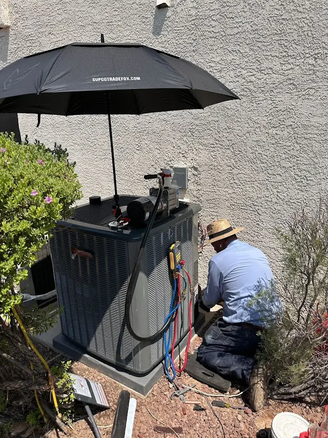 HVAC technician performing outdoor AC maintenance in Spring Valley
